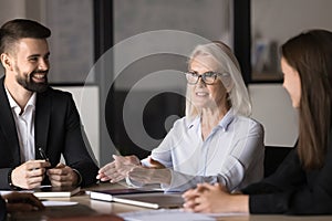 Middle-aged businesslady presenting detailed data of project at meeting photo