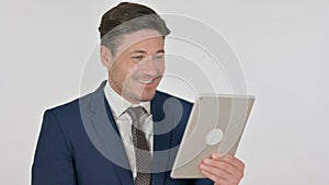 Middle Aged Businessman Celebrating on Tablet, White Background