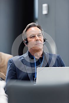 middle aged businessman in headset sitting