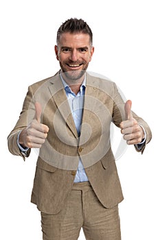 Middle aged businessman making thumbs up gesture and smiling