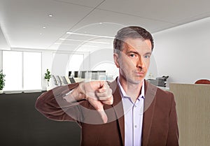 Middle Aged Businessman in an Office with Thumbs Down