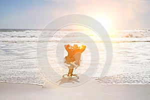 Middle aged businessman relaxing on office chair at beach