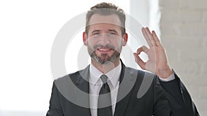 Middle Aged Businessman showing Ok Sign with Finger