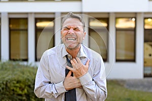 Middle-aged businessman suffering chest pains