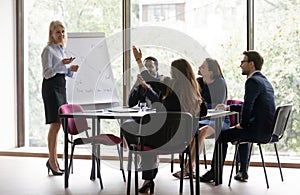 Middle-aged businesswoman interact with colleague at meeting