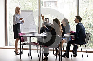 Middle-aged businesswoman interact with colleague at meeting photo