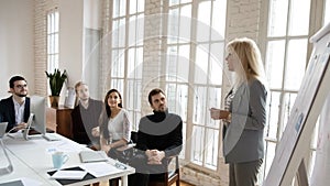 Middle-aged businesswoman present business project on meeting