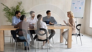 Middle aged businesswoman team leader holding corporate meeting in boardroom