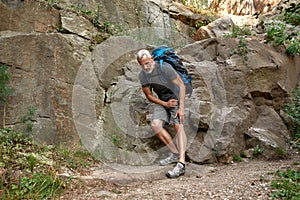 Middle aged caucasian man with injured leg trekking