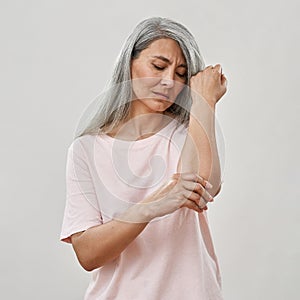 Middle aged caucasian woman touch painful elbow