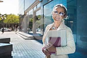 Middle-aged confident, focused and powerful business woman looking at camera. Beautiful mature lady smiling with