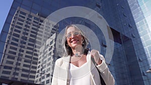 Middle-aged confident, focused and powerful business woman looking at camera. Beautiful mature lady smiling.