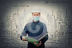 Middle aged contractor or architect holding a document folder, wearing protective helmet and face mask for protection against the