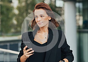 Middle-aged corporate person standing outdoors