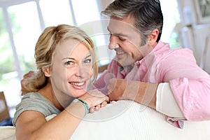 Middle-aged couple being happy at home photo