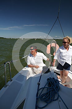 Middle-aged couple on boat sailing