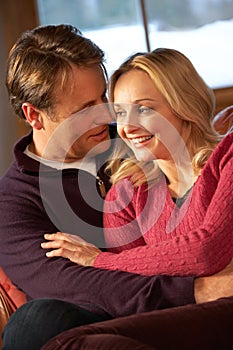 Middle Aged Couple Chatting On Sofa In Chalet