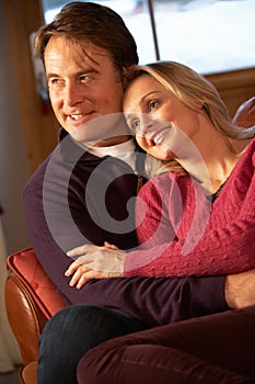 Middle Aged Couple Chatting On Sofa In Chalet