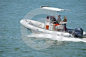 Middle aged couple cruising the Florida Intra-Coastal Waterway in a Pontoon Fishing Boat