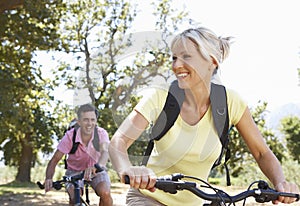 Middle Aged Couple Cycling Through Countryside photo