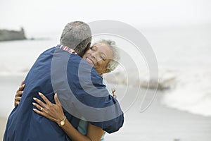 Middle-aged couple embracing at beach