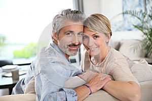 Middle-aged couple embracing at home