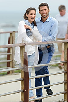 Middle aged couple enjoying view from bridge