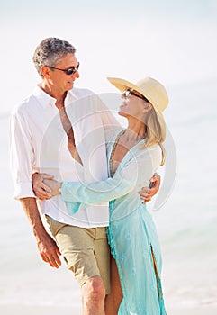 Middle Aged Couple Enjoying Walk on the Beach