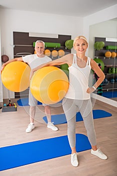 Middle-aged couple having a fitness workout and feeling good