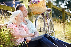 Middle Aged Couple Relaxing On Country Cycle Ride photo
