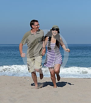 Middle aged couple on sandy beach