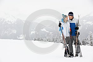 Middle Aged Couple On Ski Holiday In Mountains