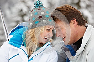 Middle Aged Couple On Ski Holiday In Mountains