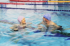 Middle Aged Couple In Swimming Pool