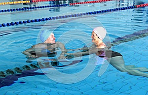 Middle Aged Couple In Swimming Pool