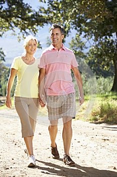 Middle Aged Couple Walking Through Countryside