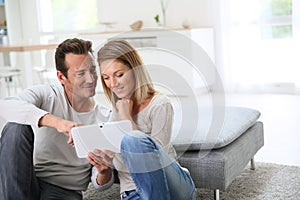 Middle-aged couple websurfing with tablet photo