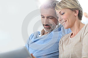 Middle-aged couple websurfing together photo