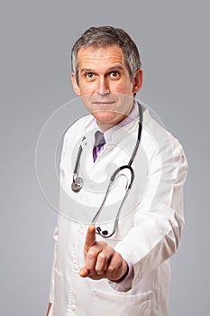 Middle aged doctor gesturing with copy space