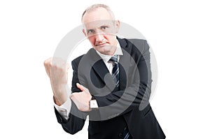 Middle aged elegant man showing obscene gesture