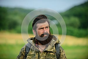 Middle aged farmer, closeup male farmer portrait. Portrait of middle aged bearded man, outdoors in meadow. Man portrait