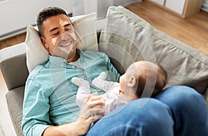 middle aged father having vitiligo with baby