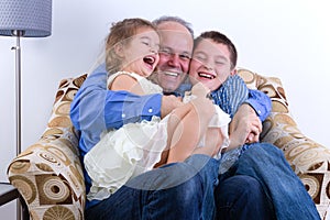 Middle-aged father with two laughing kids