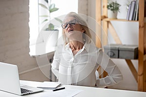 Middle-aged female employee suffer from back ache