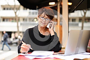 Middle aged female extramural student using laptop for