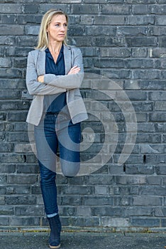 Middle-aged fit woman wearing cool slim blue jeans