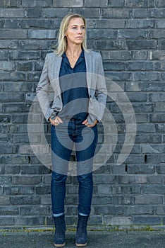 Middle-aged fit woman wearing cool slim blue jeans