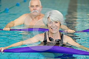 middle aged happy couple in swimming pool