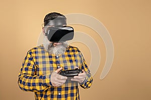 Middle-aged hipster man with virtual reality glasses and game controller