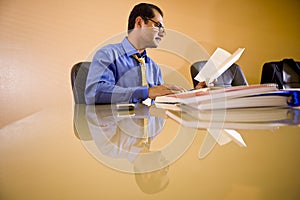 Middle-aged Hispanic businessman working in office